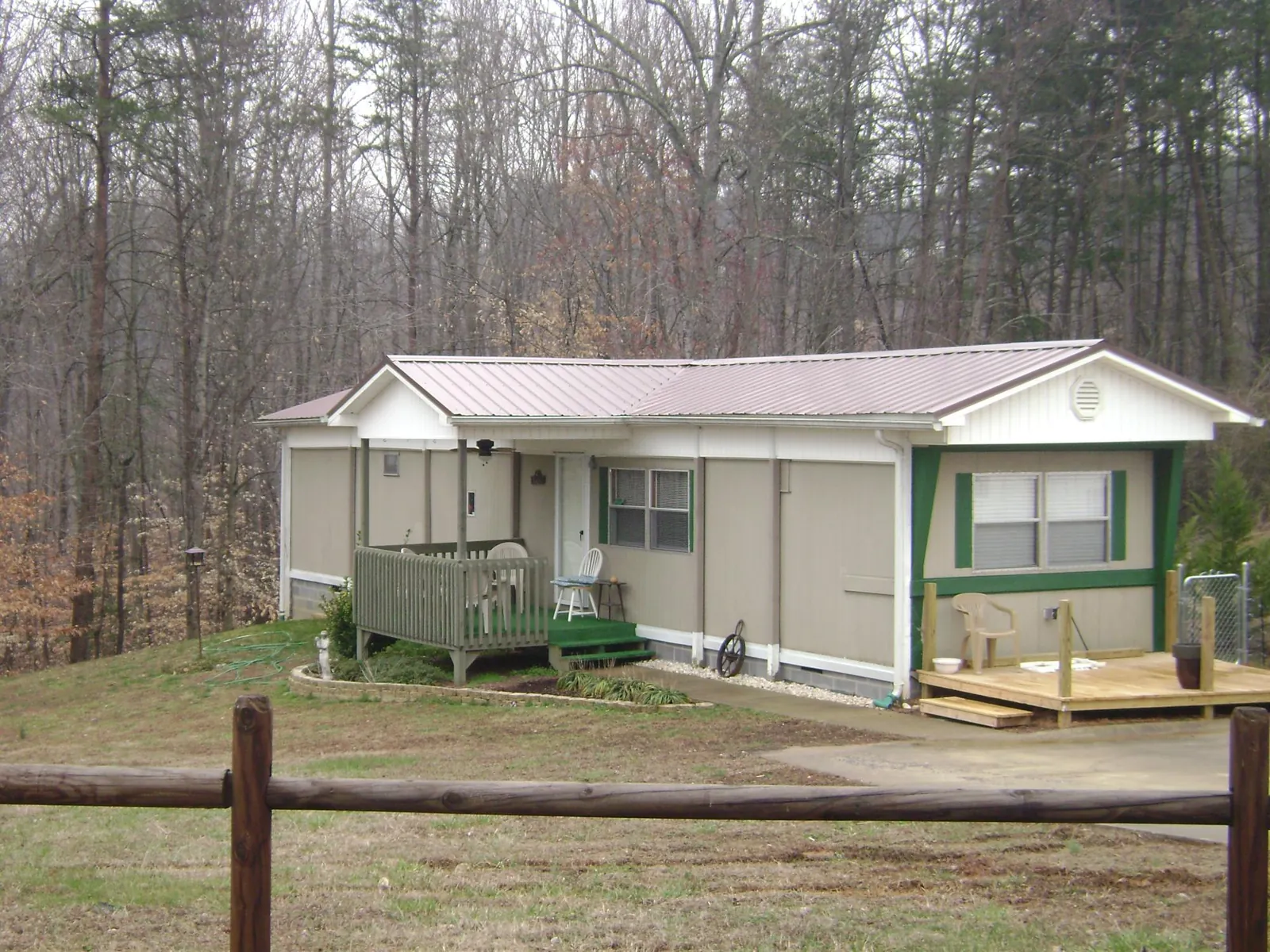 Mauve metal roof on a manufactured home with a new front deck in Holly
